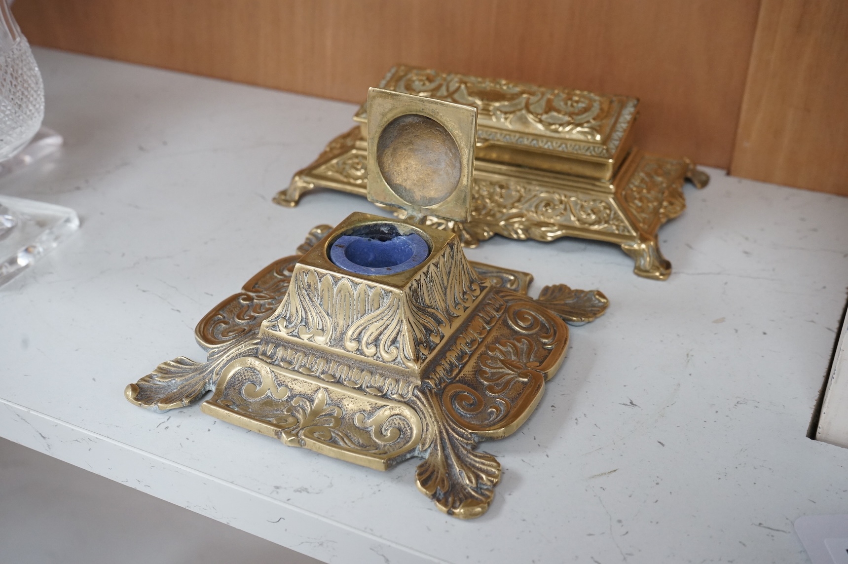 A decorative brass stamp box and a similar inkwell, largest 22cm wide
